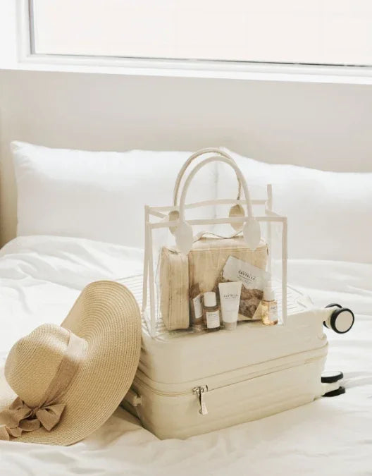 SKIN1004 Madagascar Centella travel pouch set with skincare products on a suitcase.